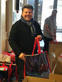 Dean Russell Packing Gifts During The GSF Basket Brigade