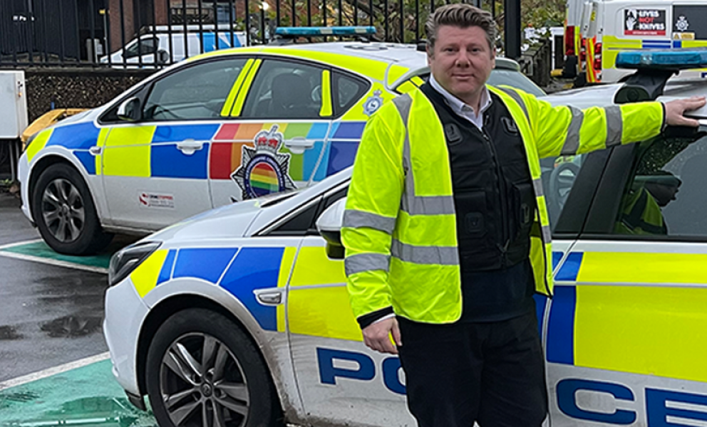 Dean Russell MP standing by police car at Watford Police Station