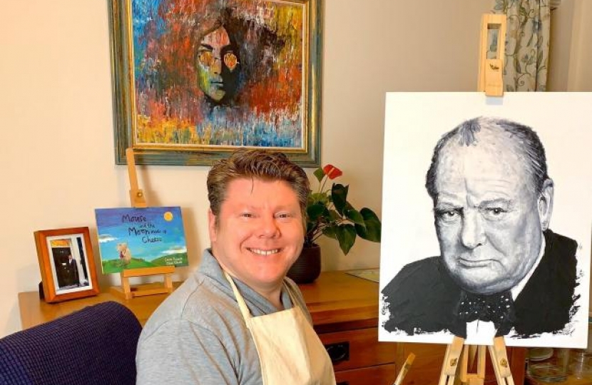 Watford MP Dean Russell with a painting based on a portrait by photographer Yousuf Karsh and a painting of John Lennon